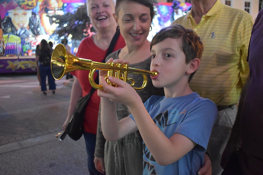 Lucas Buta plays a jazzy tune on his plastic trumpet to bring in the new year.