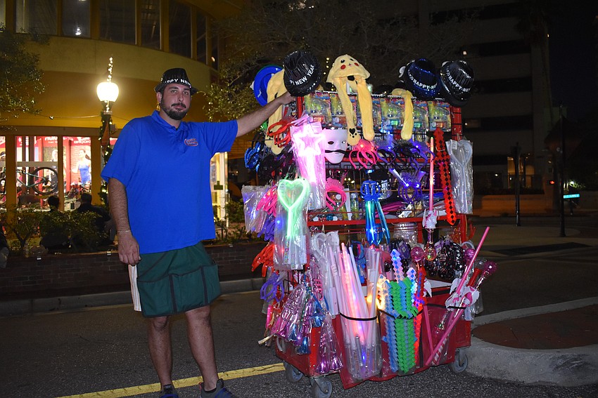 Jackson O'Neil displays and sells new year nick knacks.