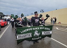 Lakewood Ranch High School's Jasmine Burden, Bryce Brielmann and Amme Cook lead the Marching Mustangs in the parade. The marching band performed in the Sugar Bowl parade and half time show.