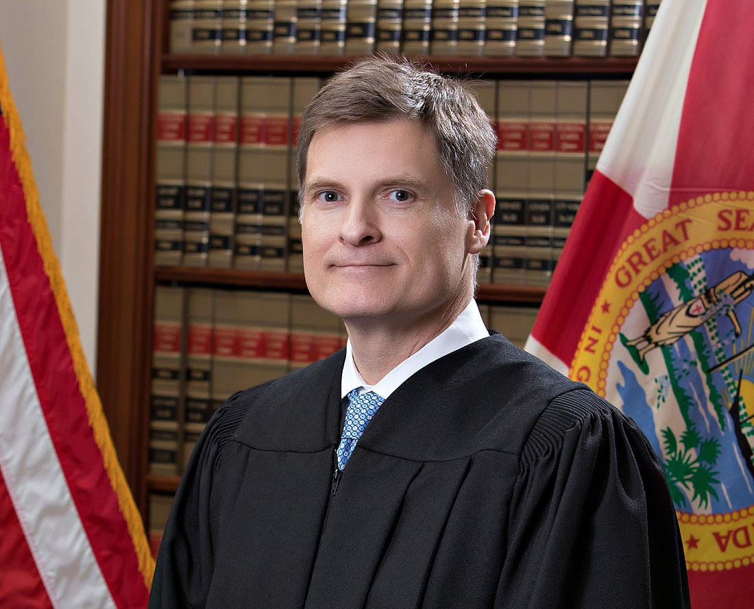 State Supreme Court Chief Justice Carlos MuÃ±iz
