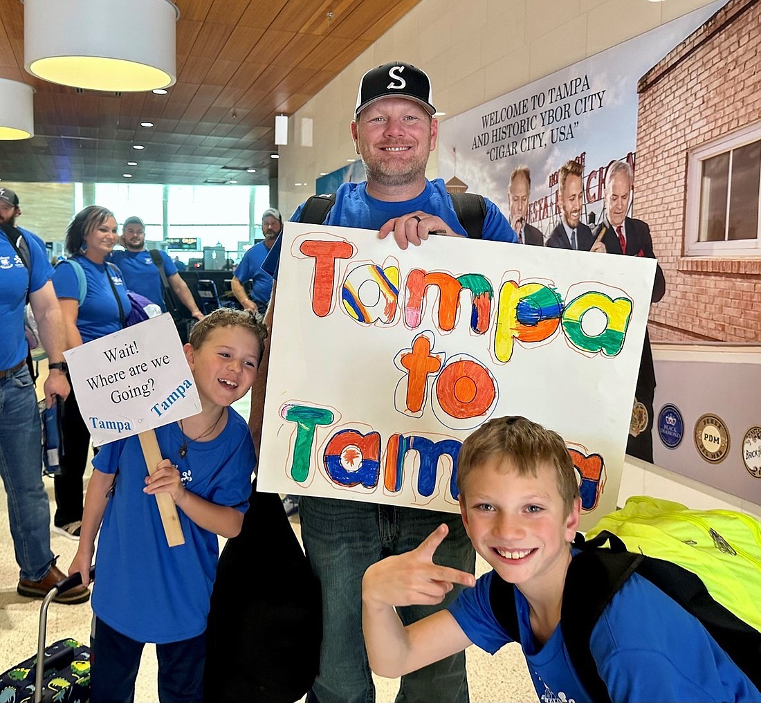 Residents of Tampa, Kansas, celebrate their arrival at Tampa International Airport on Dec. 5. (Courtesy photo)