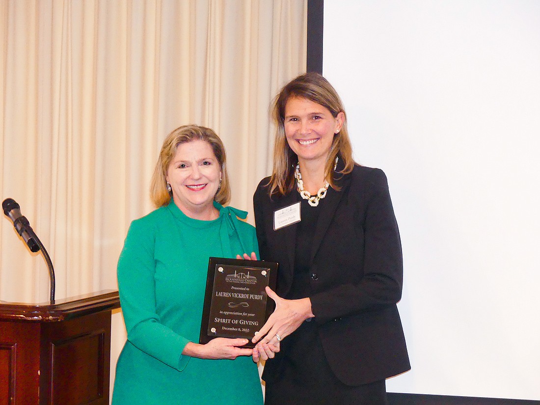 U.S. District Judge Marcia Morales Howard, left, and attorney Lauren Purdy, recipient of the Spirit of Giving Award for a civil litigator presented by the Federal Bar Association Jacksonville Chapter.
