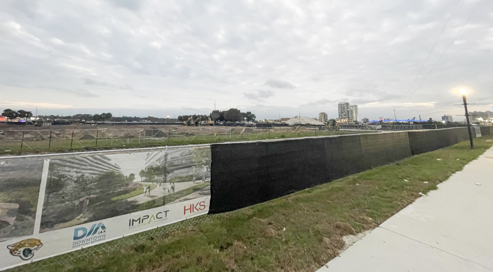 The Four Seasons site is surrounded by a construction barrier and horizonal work has begun. Renderings on the fencing show what is planned for the property.