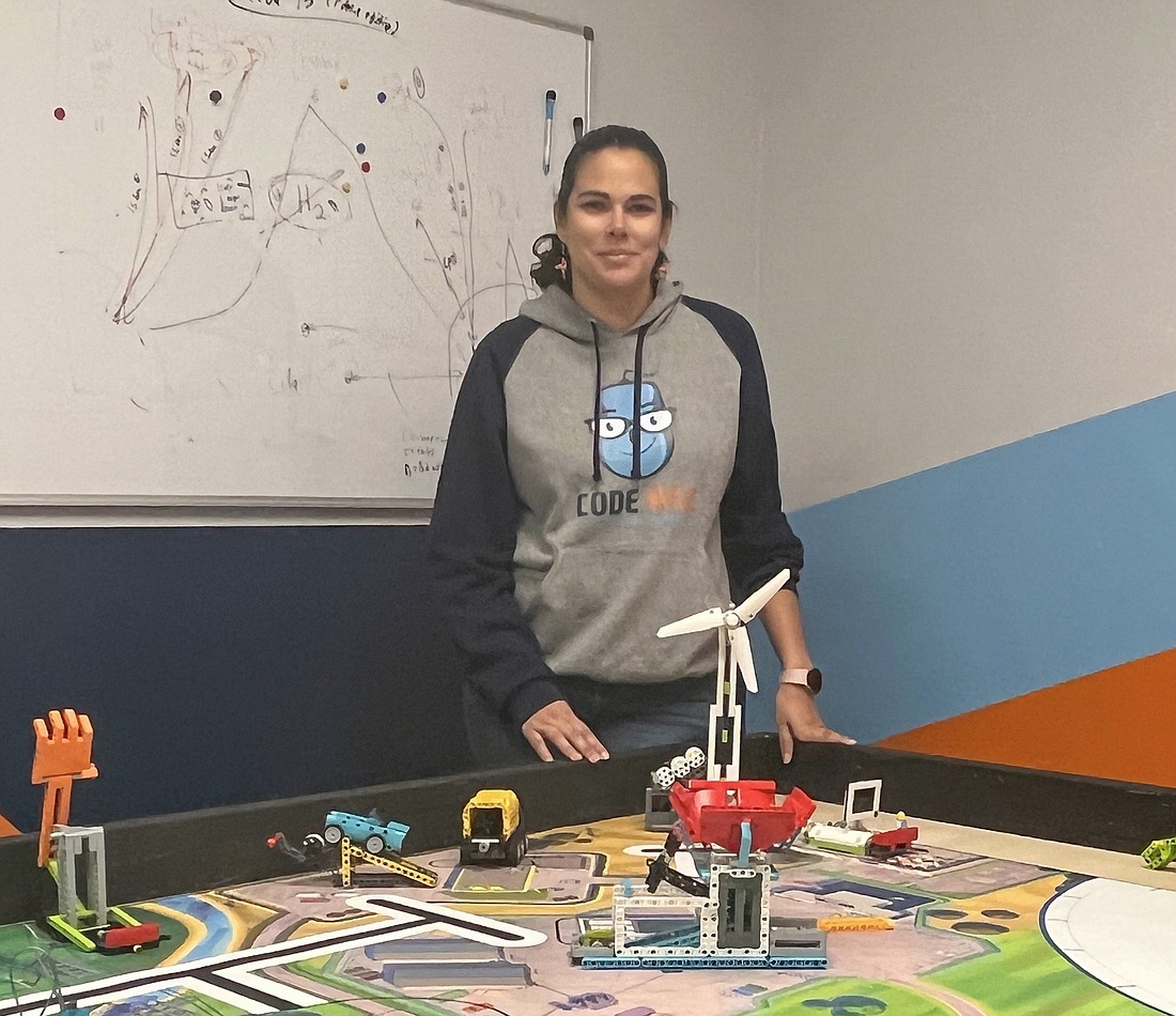 Rebeca Rodriguez with the Lego robots that students build and program at her Code Wiz franchise at 530 Florida 13, Unit 15, in Fruit Cove.