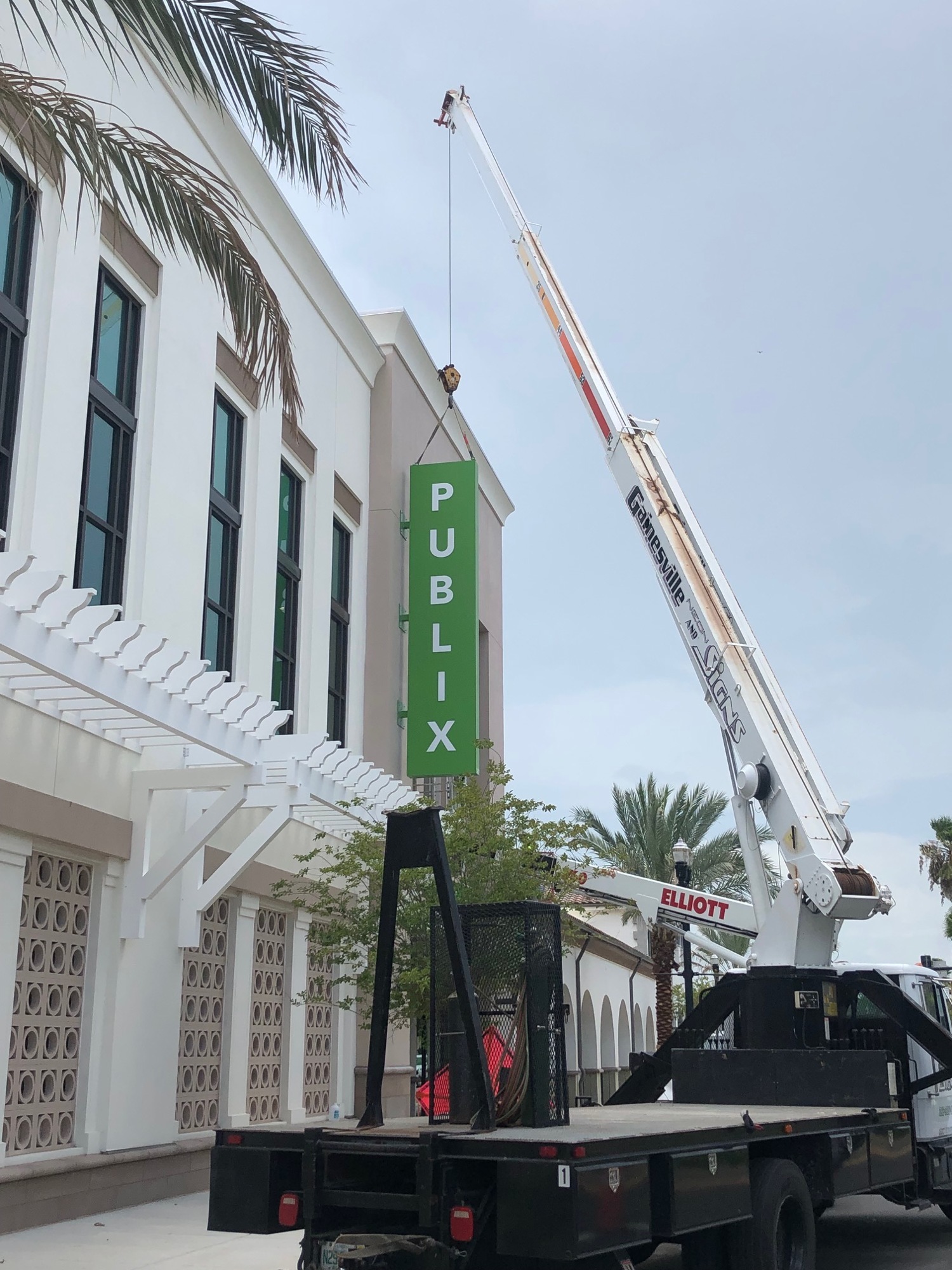 A sign is lifted into place at the San Marco Publix.
