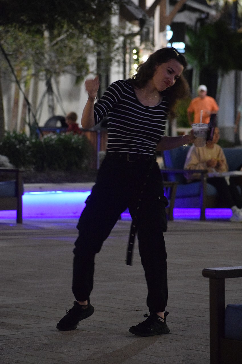 Veronica Huber, who is visiting Sarasota from California, has fun dancing to the live music.