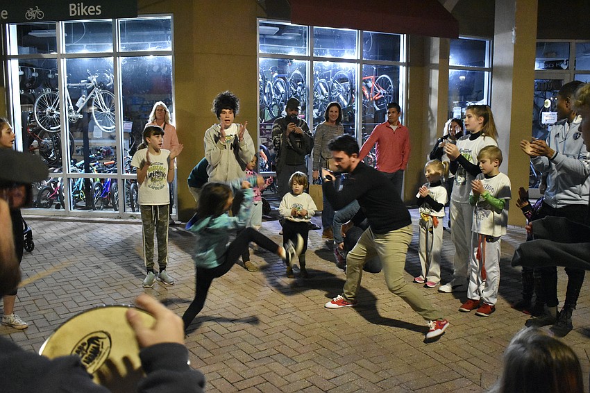 Lakewood Ranch's 8-year-old Julia Simons and her father Charles Simons demonstrate Capoeira, a type of Brazilian martial arts, with the group Capoeira Volta Ao Mundo.