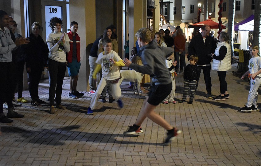 Lakewood Ranch's 8-year-old Mason Rueter and 16-year-old Kaiden Summerall demonstrate Capoeira, a type of Brazilian martial arts, with the group Capoeira Volta Ao Mundo.