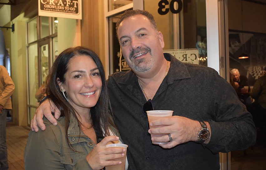Friends Sapphire Point's Carolyn Tovell and Lakewood National's Kevin Lowerre are pleased with the drinks they found at Craft Growlers to Go.
