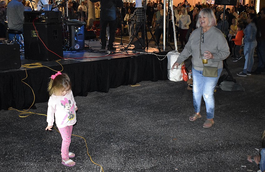 Lakewood Ranch's 3-year-old Cora Hafdahl and Ardis Hafdahl enjoy the music up close as they dance beside the stage.