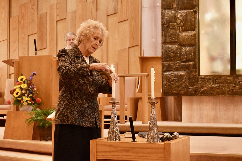 Suzanne Schuster lights the Shabbat candles.