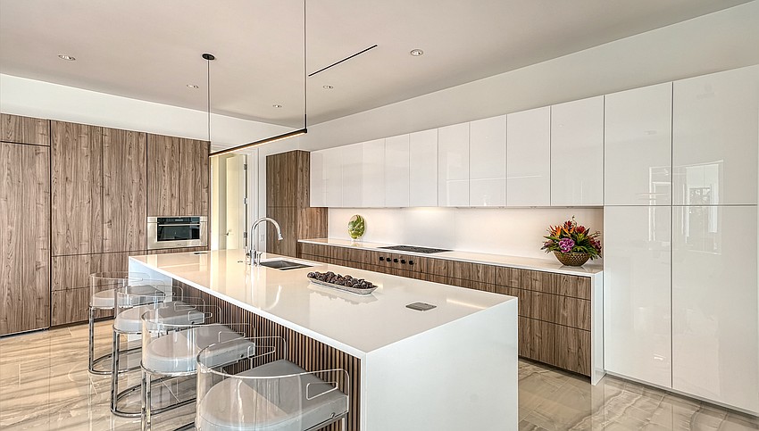 Sleek, touch-latch cabinets are featured in the kitchen.