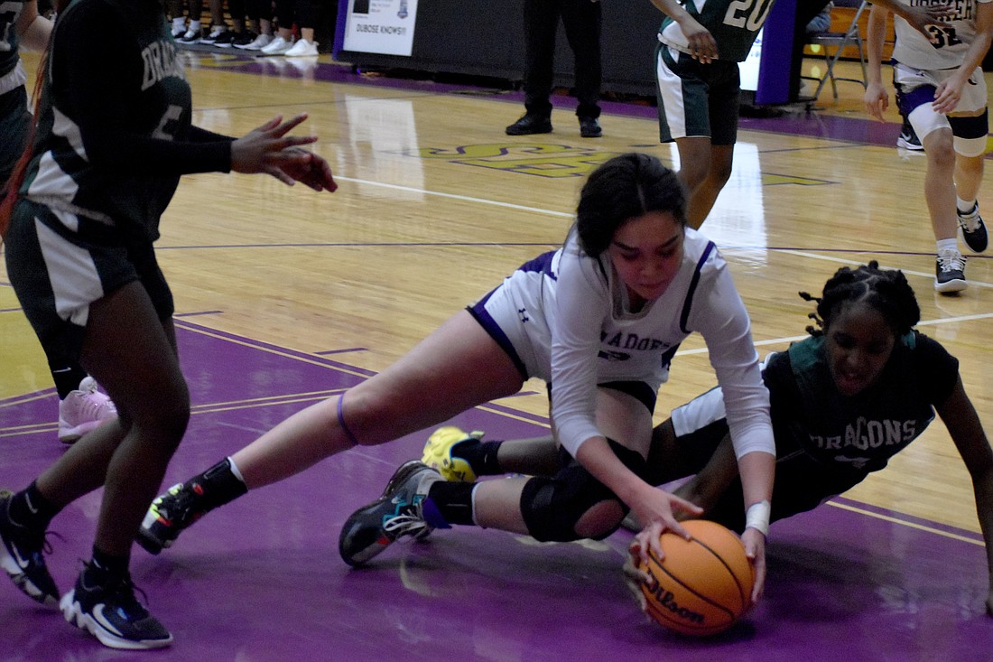 Booker's Annette Castro dives for a loose ball against Lake Placid High.