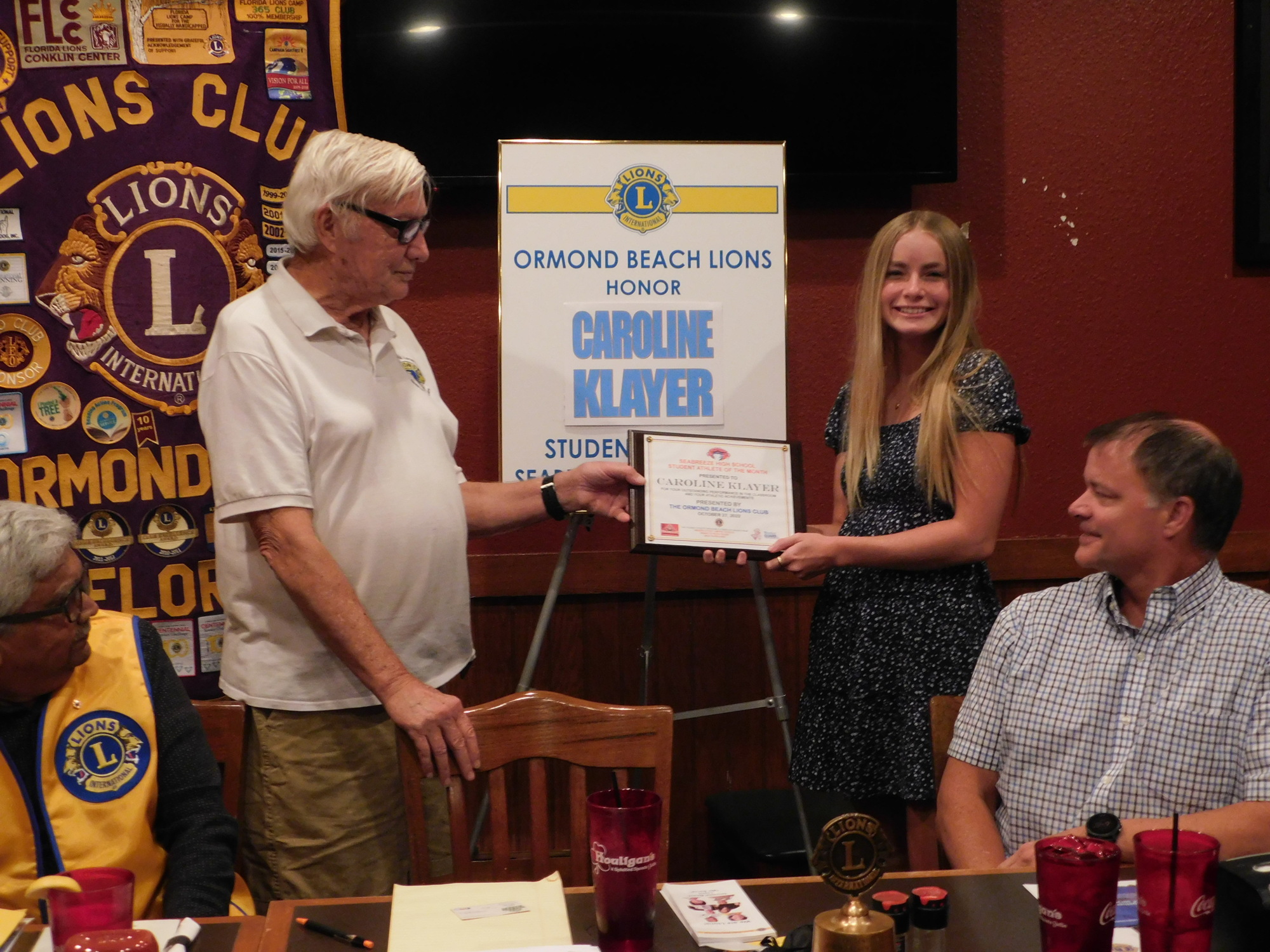Hank Lunsford, president of the Ormond Beach Lions Club, presents Caroline Klayer with a plaque. Courtesy photo