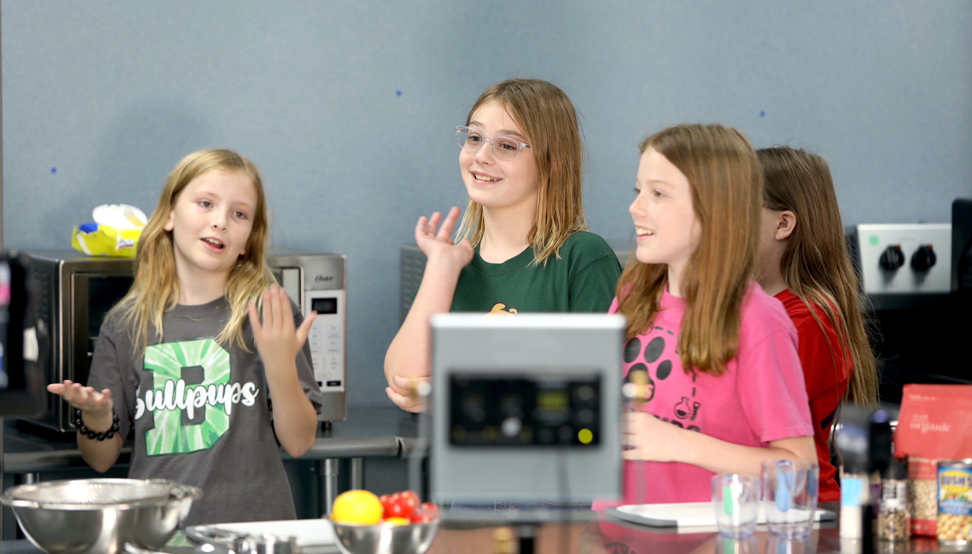 Ava Blanchard, Caroline Irving and Melissa Ryon in the cooking show area in Catherine Zanella's classroom at Bunnell Elementary School. Photo by Brent Woronoff