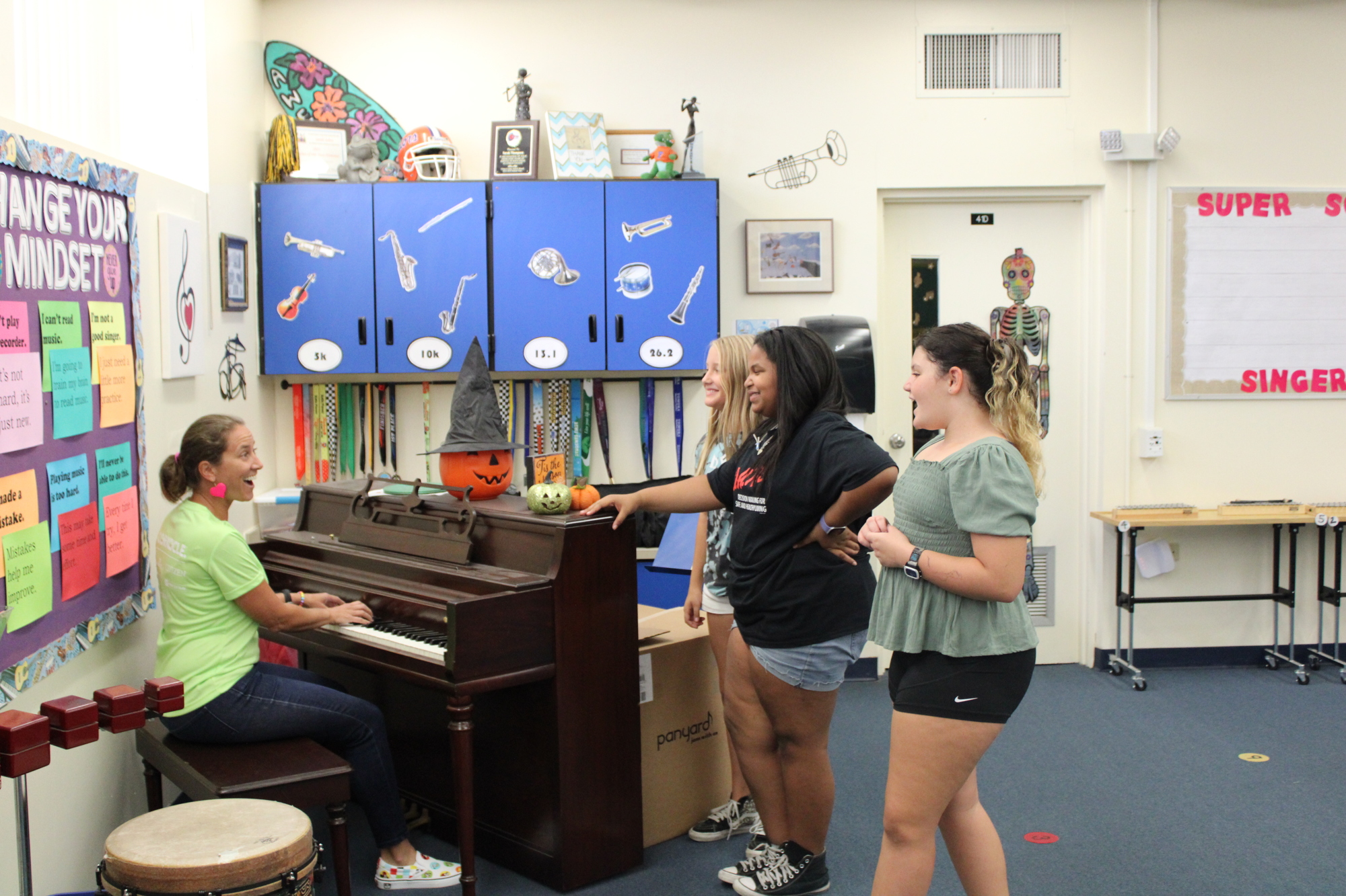 Sara Johns and her students — Rena Raymond, Amaya Mathon and Adele Rae — practice for the All-State concert. Photo by Alexis Miller