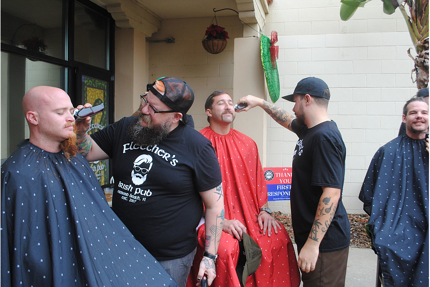 Men get their beard shaved during the second-annual Shave for the Brave event in 2021. File photo by Julia Ambrose