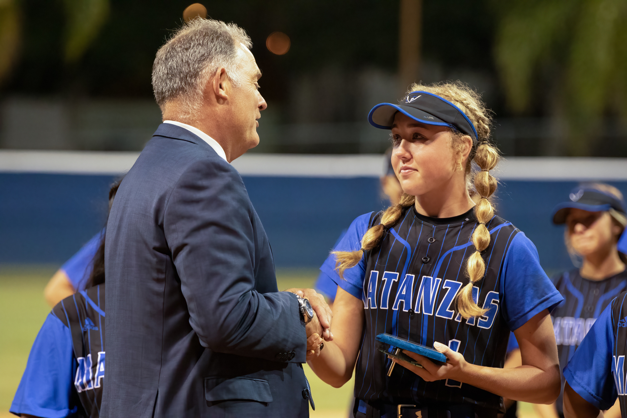 Principal Jeff Reaves presents Emma Wood with Matanzas' female athlete of the year award at the regional softball quarterfinal on May 11 at Daytona State College. File photo by Jake Montgomery