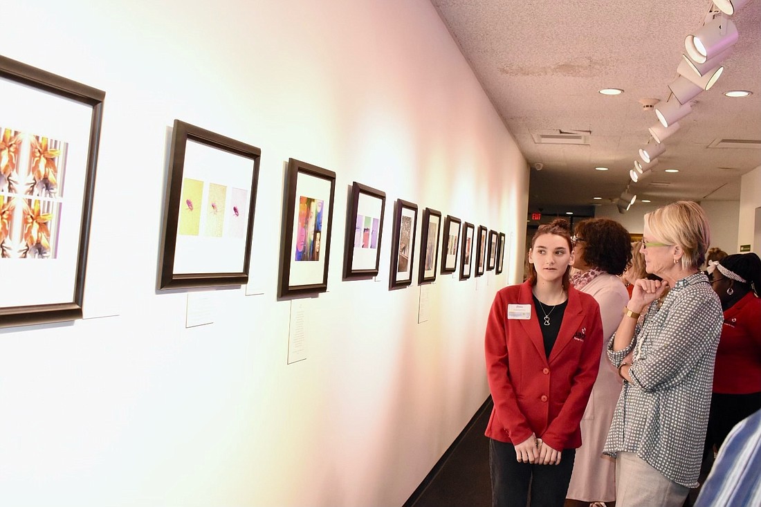A Pace girl speaks to a museum guest during the opening reception on Dec. 9. Photo by Brittney Hughley-Thompson