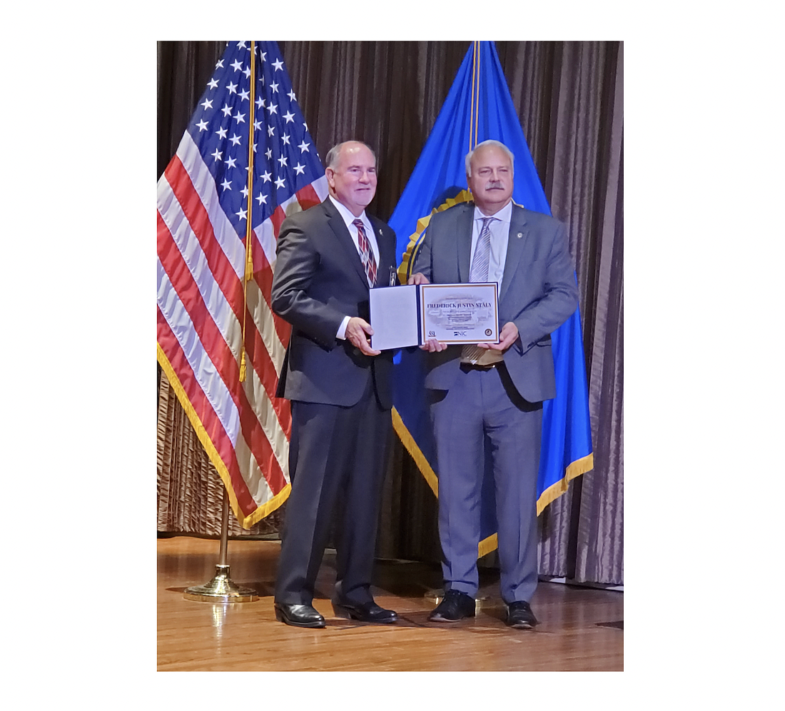 Flagler County Sheriff Rick Staly accepts his certificate from NCI Jails Division Chief Stephen Amos. Photo courtesy of the Flagler County Sheriff's Office