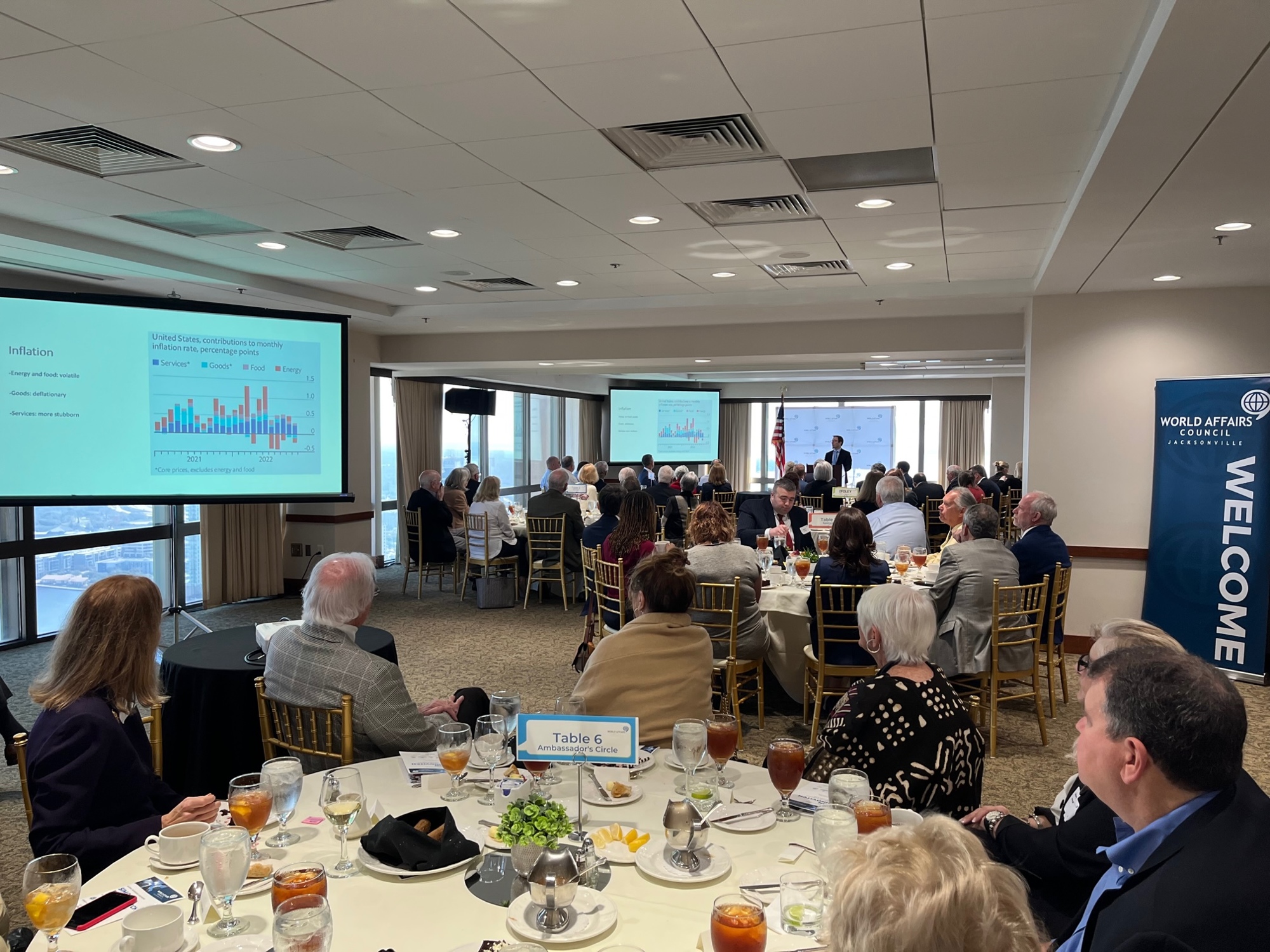 The crowd at the Downtown River Club watches the speech by Simon Rabinovitch.