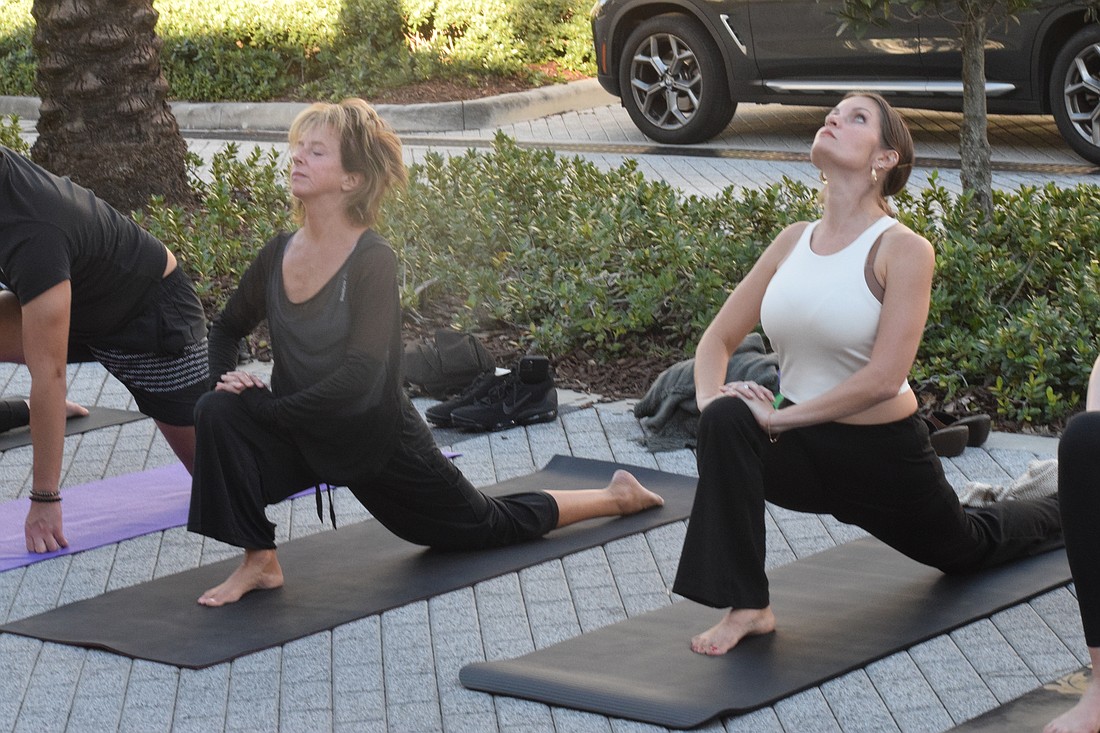 Lakewood Ranch's Stephanie Peabody, who is the founder of the Brian Health Initiative, and Lakewood Ranch's Heather Lyon have fun during the yoga class. Lyon says the class was excellent and rejuvenating.