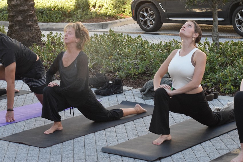 Lakewood Ranch's Stephanie Peabody, who is the founder of the Brian Health Initiative, and Lakewood Ranch's Heather Lyon have fun during the yoga class. Lyon says the class was excellent and rejuvenating.