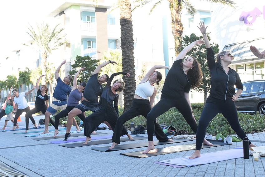 People participate in the yoga class during Sirius Day Spa's New Year, New You event. The event is supporting Sisterhood for Good.