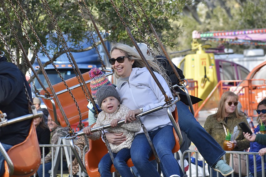 Parrish 3-year-old Harper Dillon and her mother Ashley Dillon enjoy a swinging Manatee County Fair.