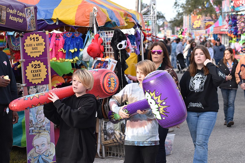 Myakka City's Wendell Lanier, Parrish's Oliver Empsall, and Myakka City's Mellanne Coddington and Jacy Lanier explore the fairgrounds.
