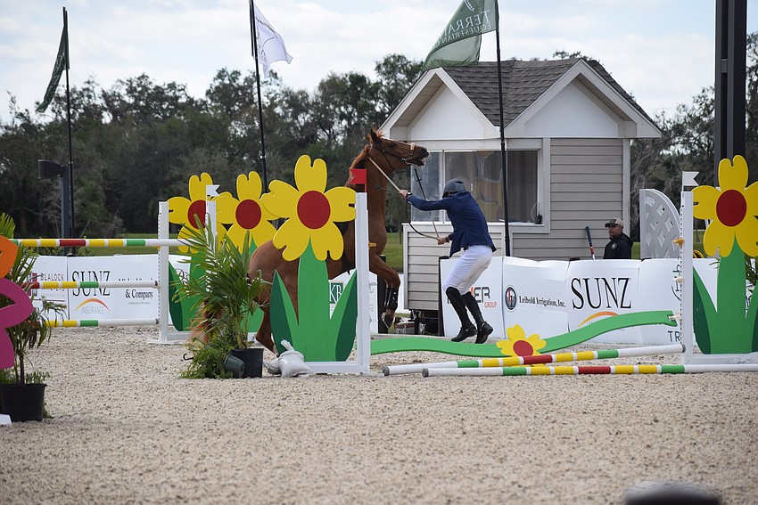 Craig Starr masterfully swings himself around and lands on his feet after coming out of the saddle aboard Christian Dior.