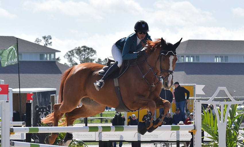 Haley Gassel soars over a jump on Iliano Van D'Abelendreef but failed to complete a clean run which took them out of the competition.
