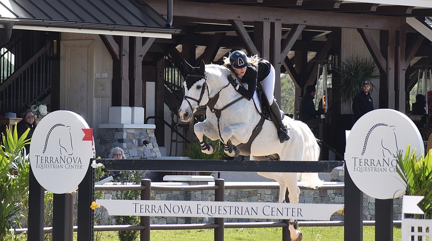 Eventual winner Kristen VanderVeen takes a jump with Faustino de Tili, one of three entries she had. She won aboard Jireh.
