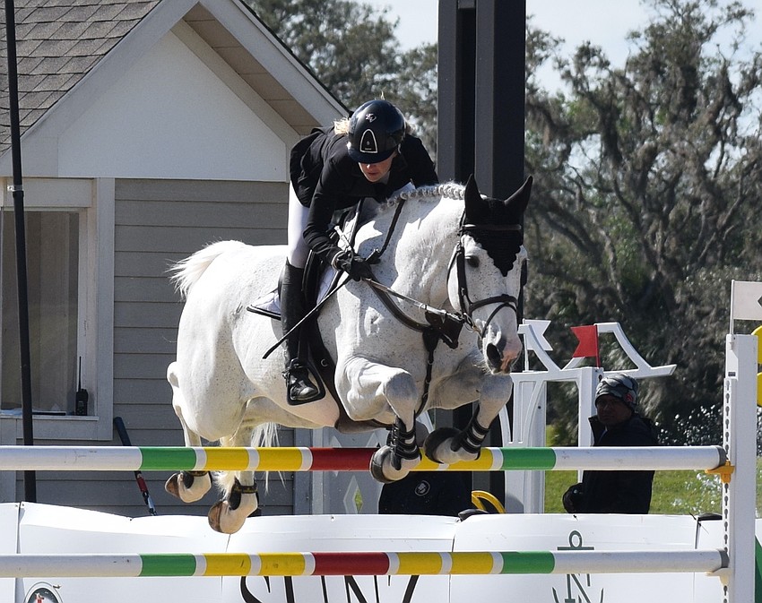 Kristen VanderVeen hugs Faustino De Tili as they go through a jump together, but they failed to finish a clean run.