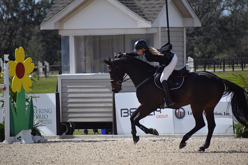 Kristen VanderVeen gives Jireh a job well done pat after their fast, clean run in the jump offs secured the championship.