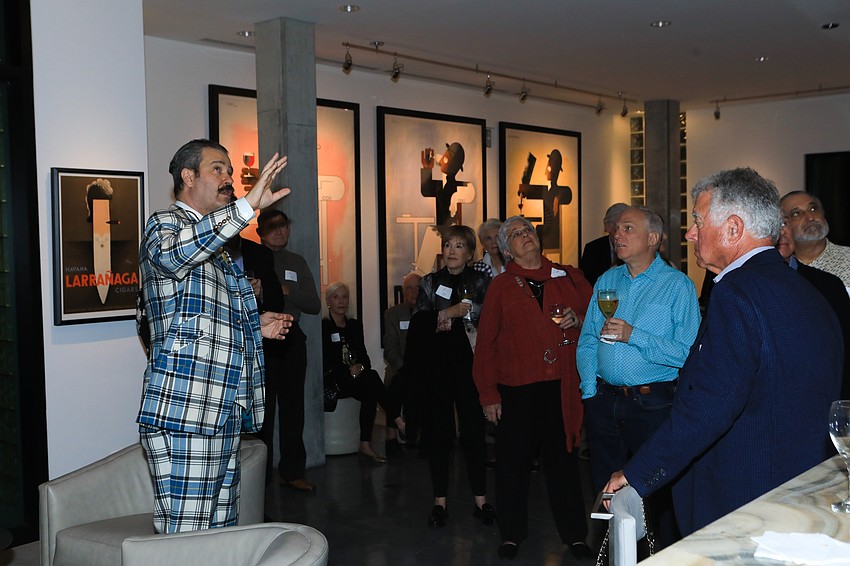 Nicholas Lowry teaches the assembled audience about the many posters and designs on display.