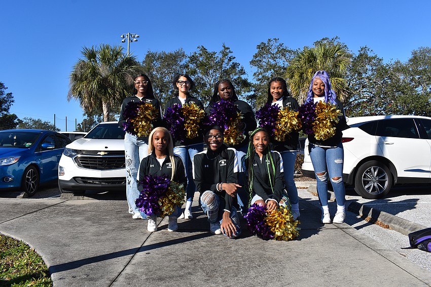Booker High School cheer team preps for the start of the march.