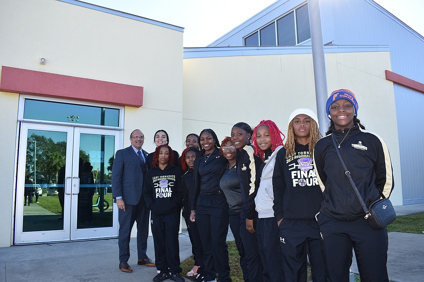 Chief of Police Rex Troche and Booker High School's girls basketball team gathers together for a pre-march picture.