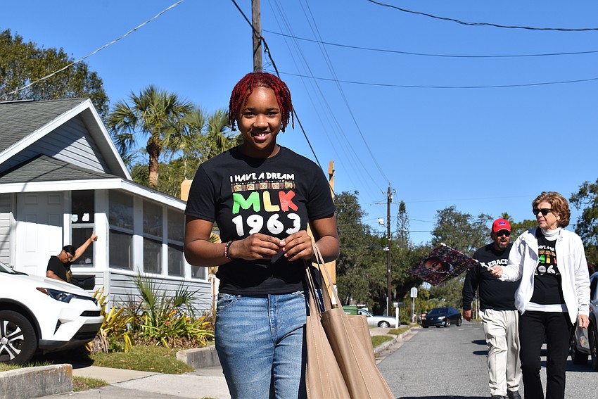 Zionna Gamble hands out candy to Newtown neighbors and families.