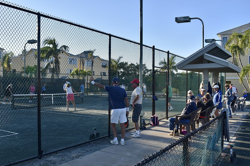 Players gather around the clay courts for a pickleball tournament at Cedars on Thursday.