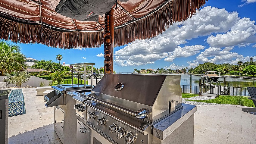 An outdoor kitchen is part of the back yard features.