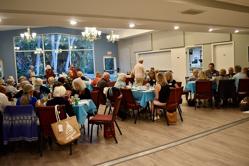 Members of the Longboat Island Chapel gather to collect coats and enjoy happy hour.