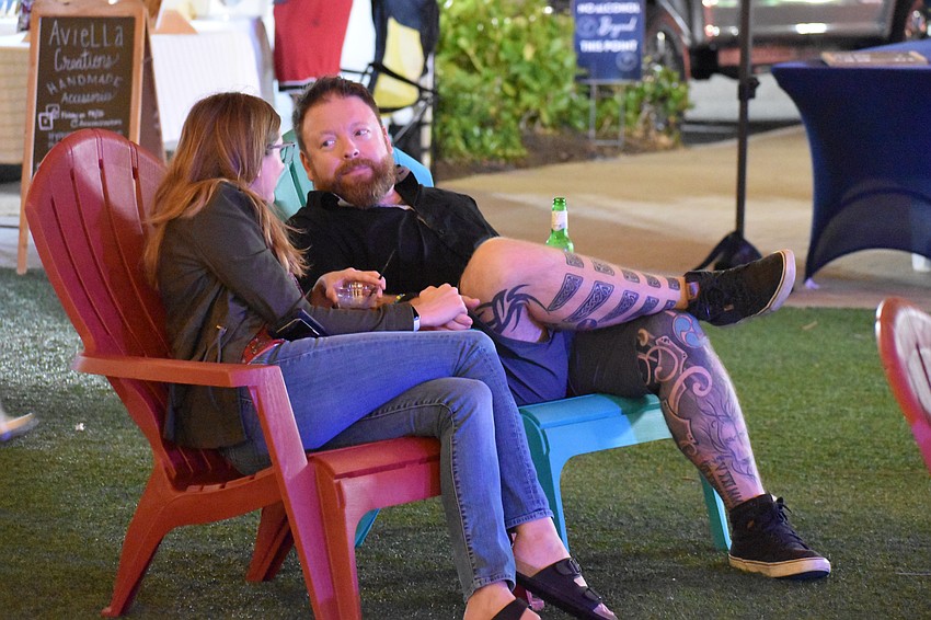 Parrish's Sarah Whipple and Jefferson Millar relax while listening to the live music at the Night Market at UTC.