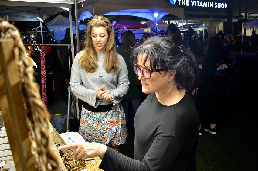 Driftheory owner Danielle Ferrantino helps Lakewood Ranch's Debra McWaters make a jewelry selection during the Night Market.