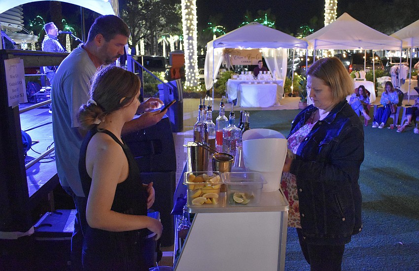 Georgie's Garden Cafe's Frank Smith and Alyssa Ennis serve a drink to Lakewood Ranch's Deanna Hawley.
