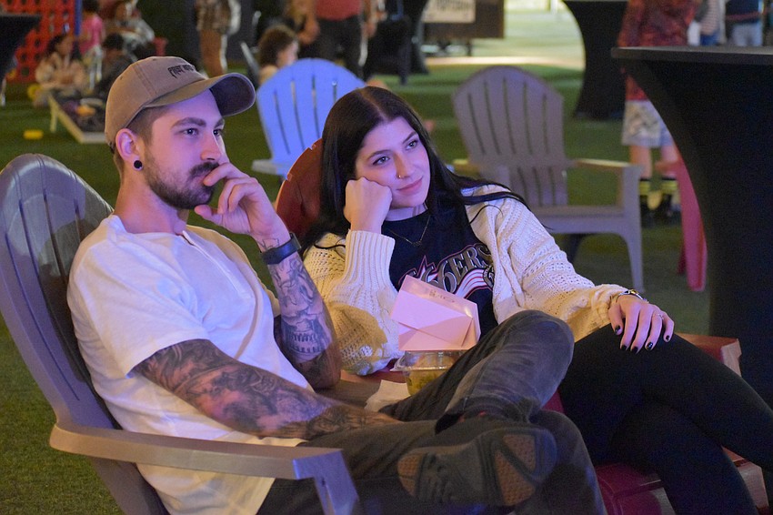 Sarasota's Alex Wiederhold and Megan Brown watch the performance by Kingpin Band.