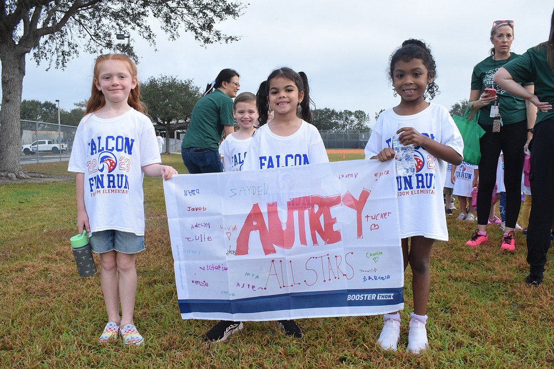 Freedom Elementary School's Jenessa Bunker, Jakob Flemming, Camila Aviles-Pagan and Mya Barrett lead the Autrey All Stars onto the track.