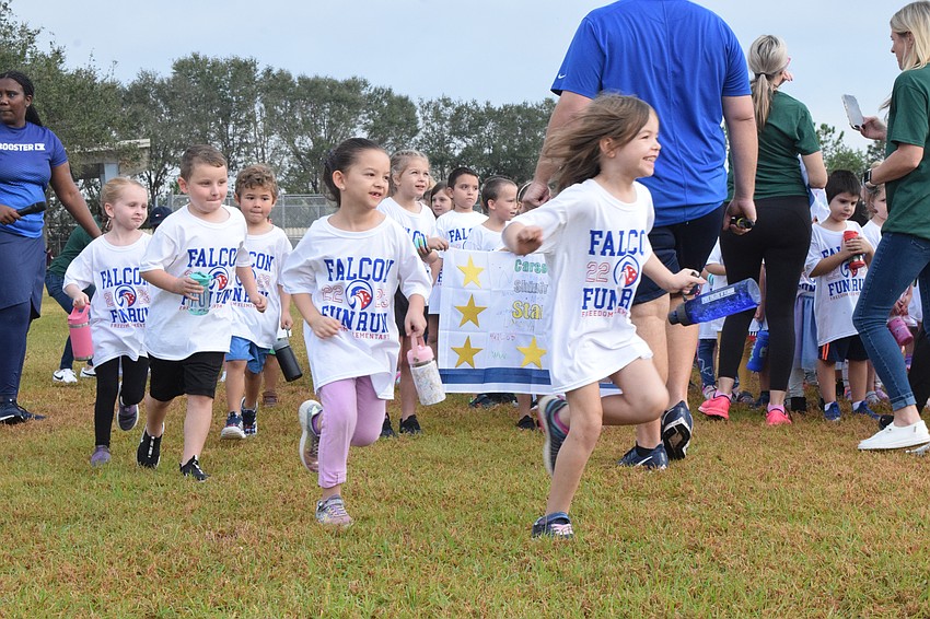 Freedom Elementary School students race toward the track.