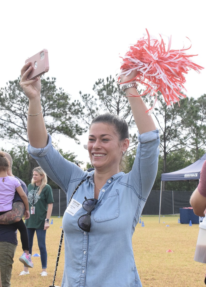 Nathalie Noa is excited to see her daughter Victoria Noa, who is in pre-K at Freedom Elementary, run around the track. 