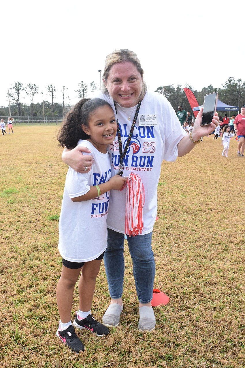 Freedom Elementary School first grader Sophia Gambrell has fun participating in the Fun Run with her mother, Melanie Stern.